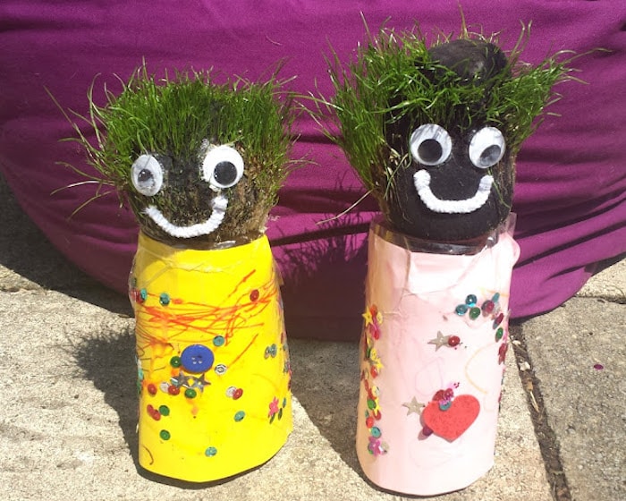 Two grass people made out toilet roll tubes