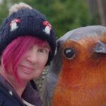 female-birdwatcher-robin-statue-selfie