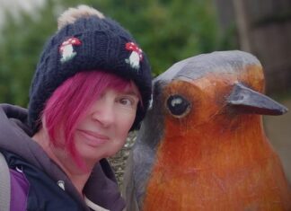 Featured Bird Watcher: Nadia Hubbard Female birdwatcher with robin statue