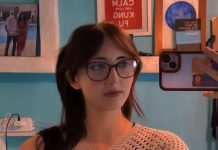 Featured Bird Watcher: Sydney Jones Mirror selfie of a young woman with shoulder-length dark hair and glasses wearing a neutral knit top in a bright room.